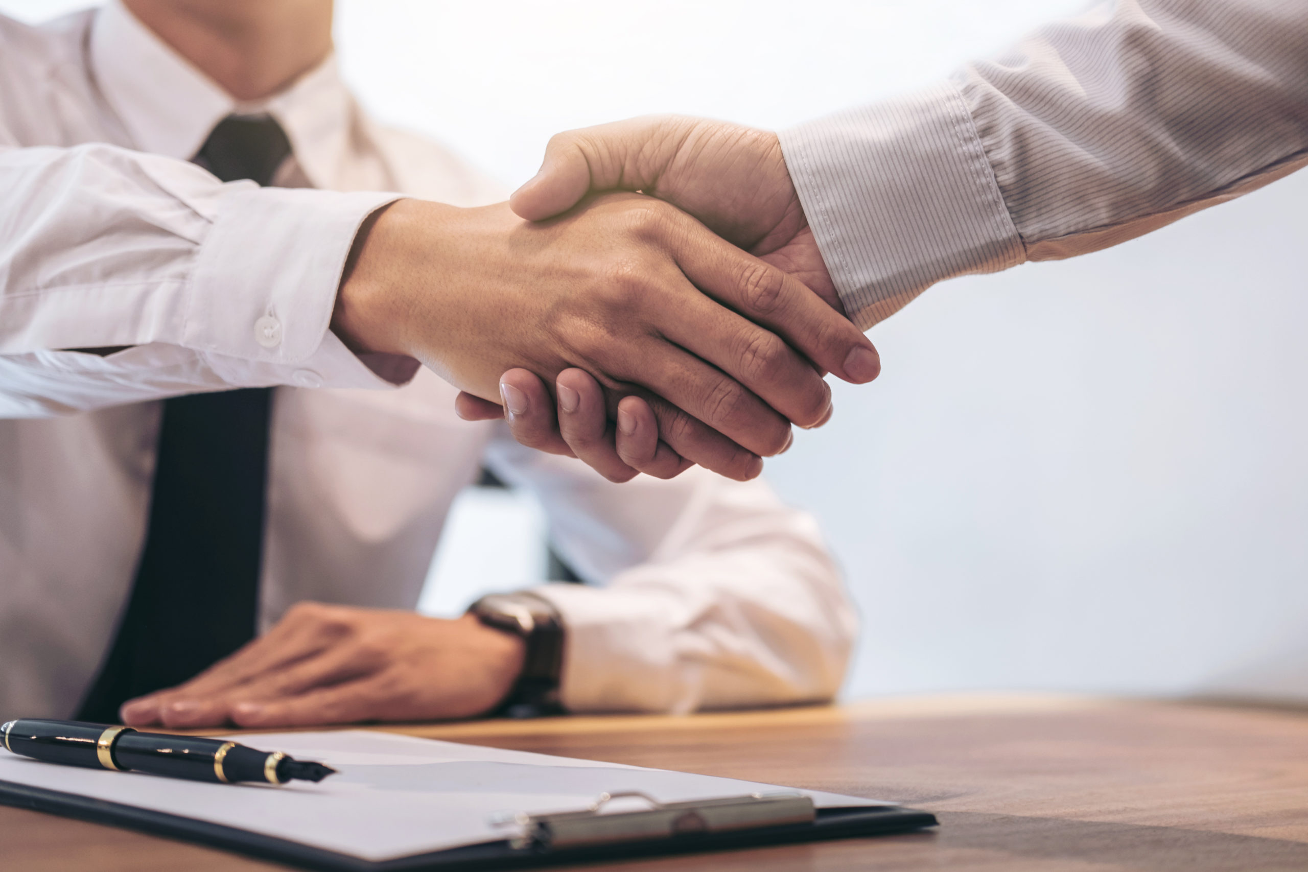 Real,Estate,Broker,Agent,And,Customer,Shaking,Hands,After,Signing